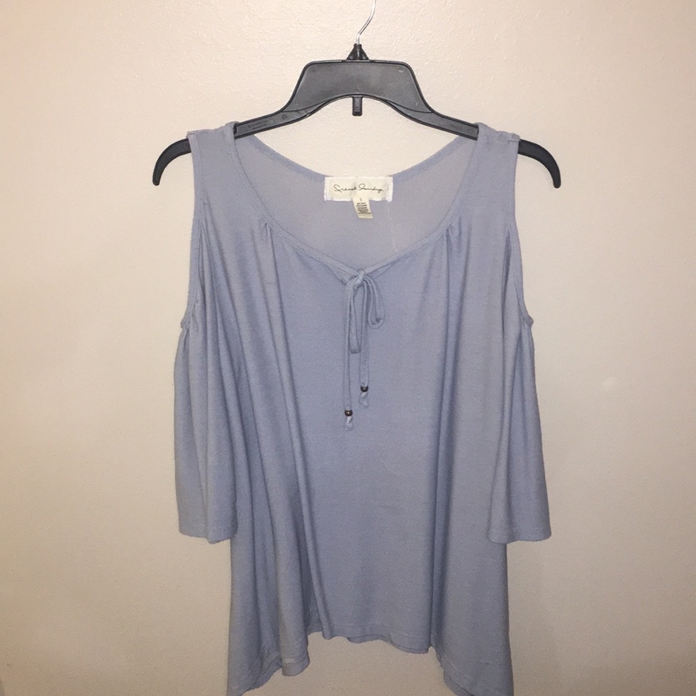 Women’s blouse with cutout shoulders.